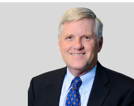 headshot of man in suit with tie